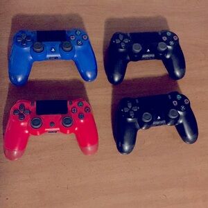 4 PlayStation 4 controllers/ 2 black/ 1 red/ 1 blue